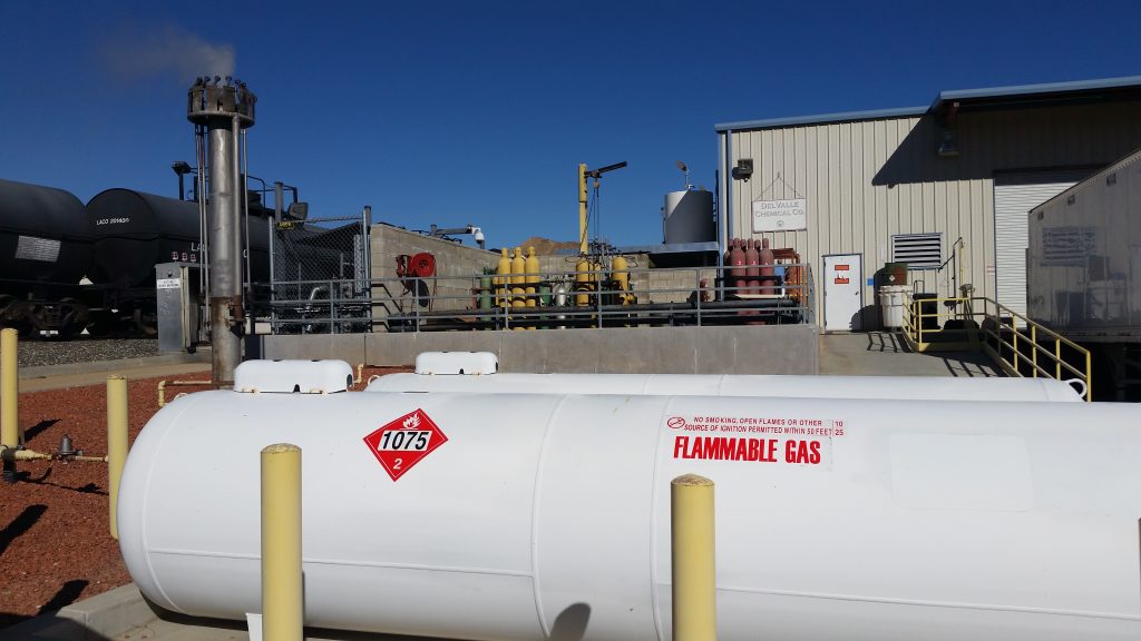 large tank with flammable gas warning